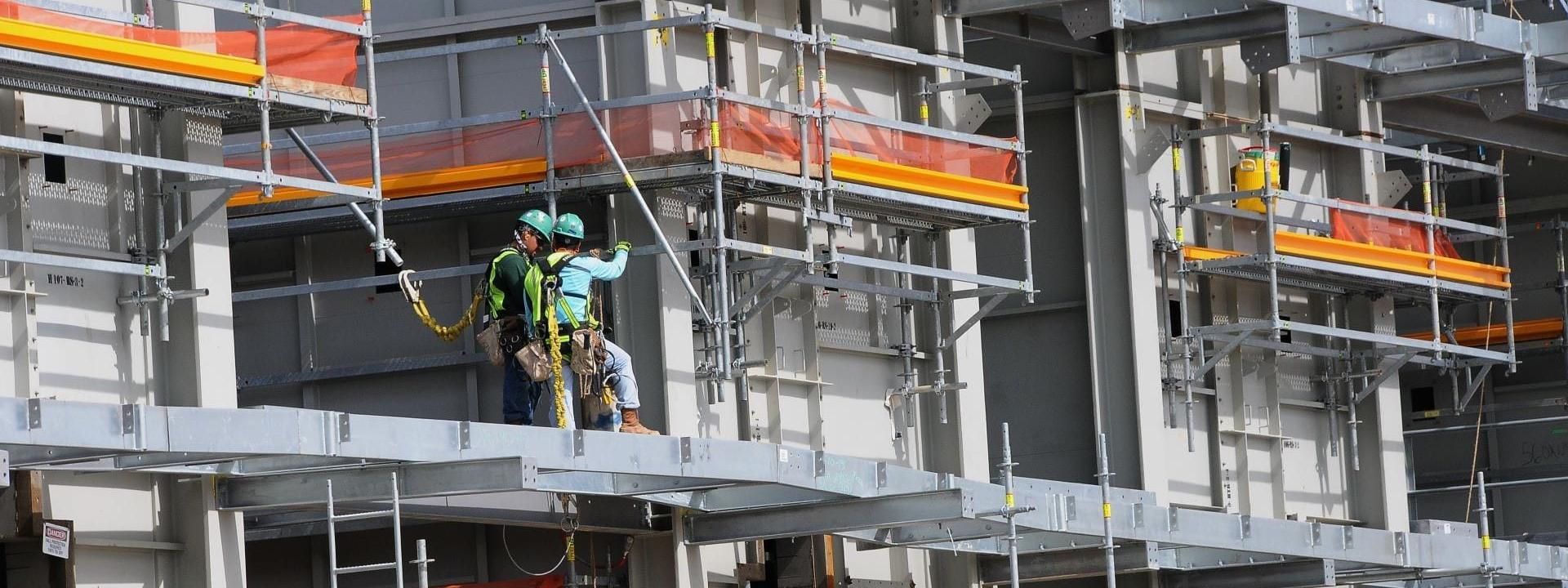 Two employees working on development of the Golden Triangle Polymers Company plant